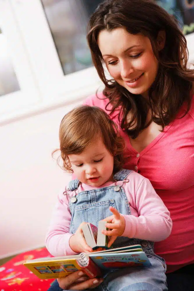 Mother and her baby reading book